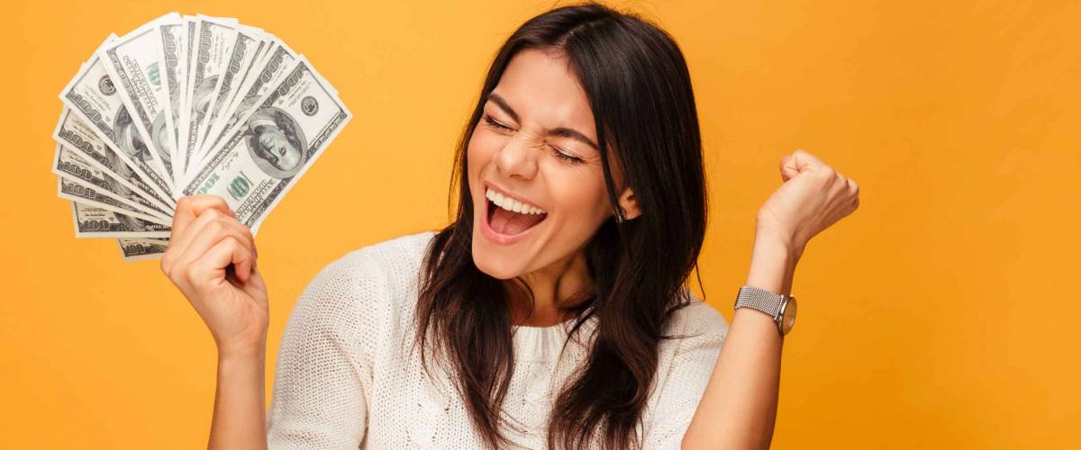 A young woman celebrating her financial savings.