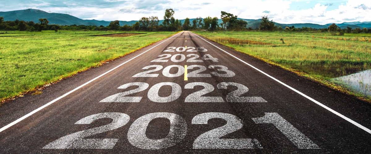 2020-2025 written on highway road in the middle of empty asphalt road and beautiful blue sky. Concept for vision 2021-2025.