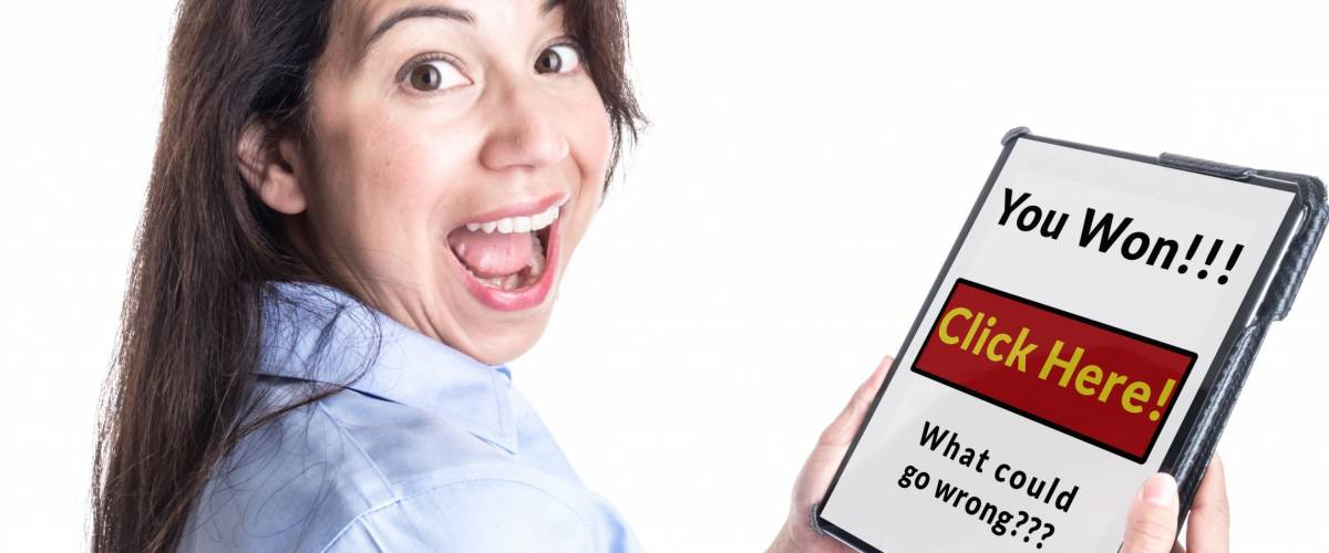 A young woman is overjoyed by message on her tablet computer stating she has won a prize, not realizing it is a scam.