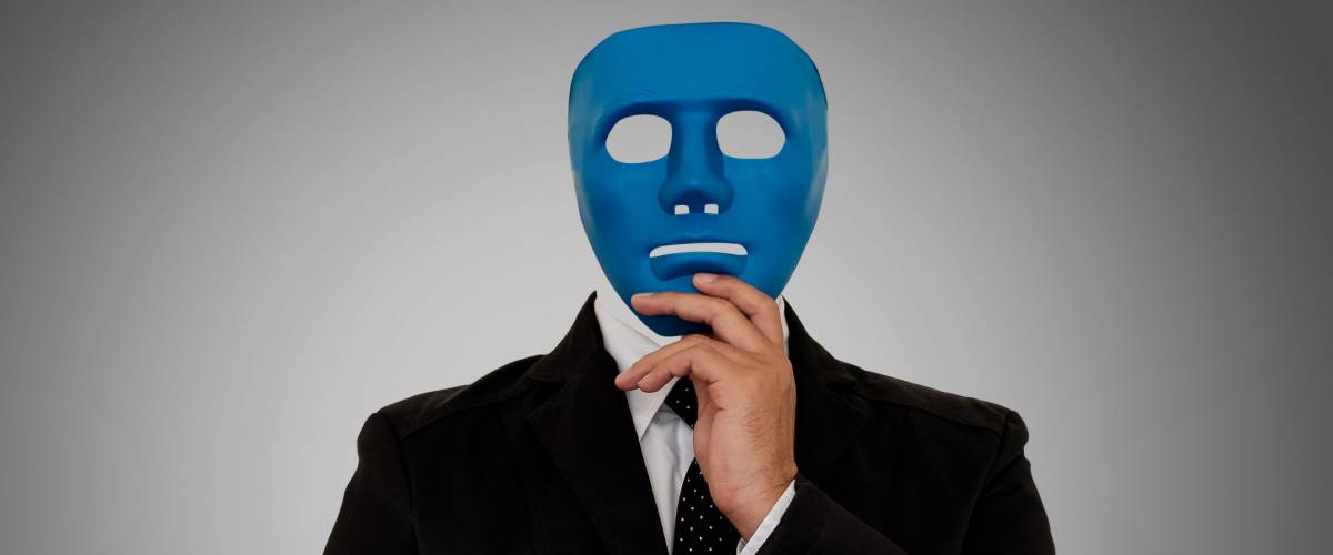 Businessman wearing blue mask on gray background with clipping path. Someone who wears a mask when socializing.