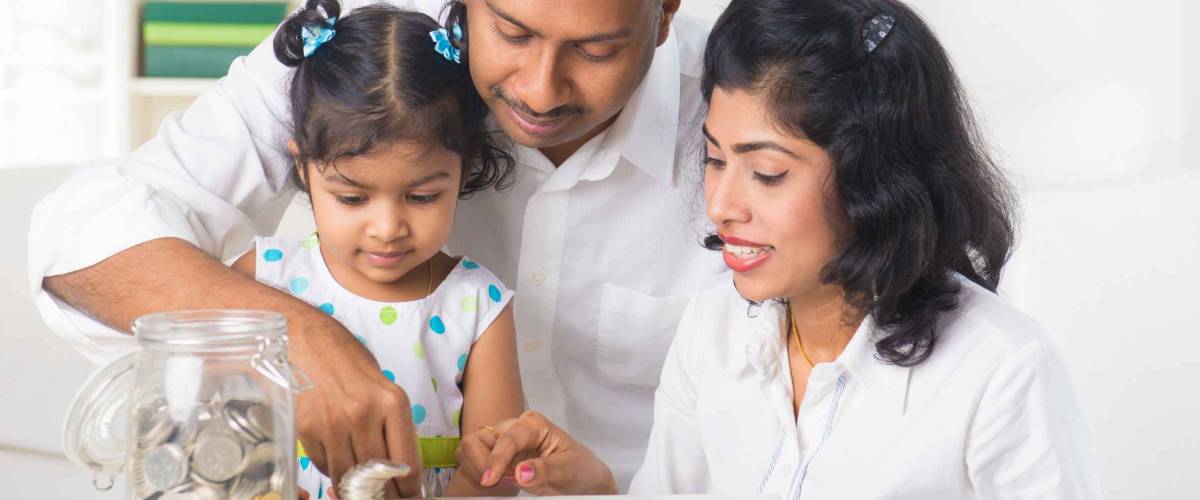 indian family teaching children on savings and financial planning