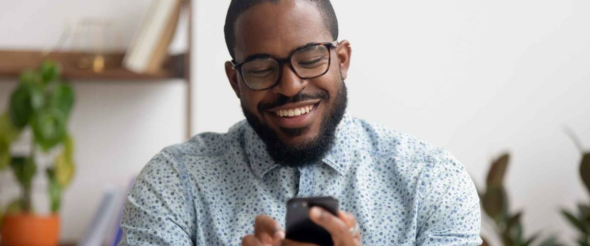 Happy african american businessman using phone