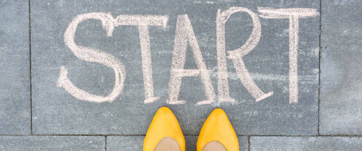 Word start on the asphalt and feet woman