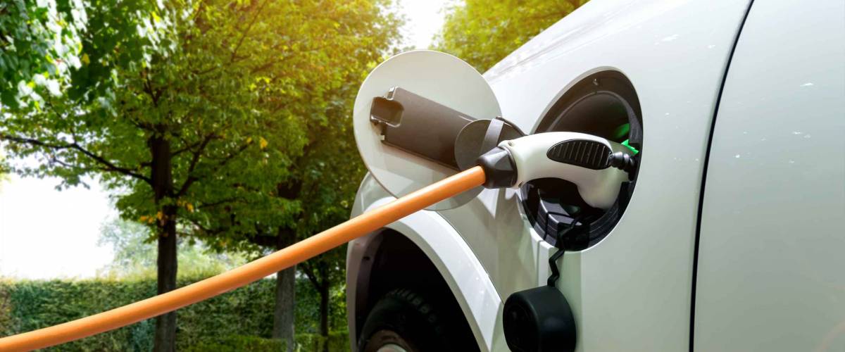 Charging an electric car with the power cable supply plugged in.Flare light effect