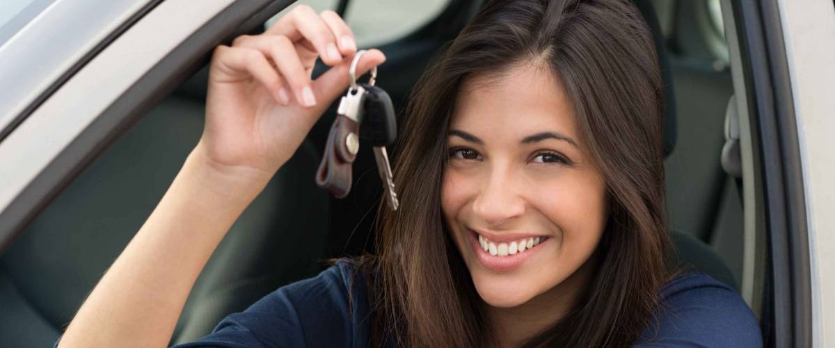 Young Happy Woman Showing The Key Of New Car