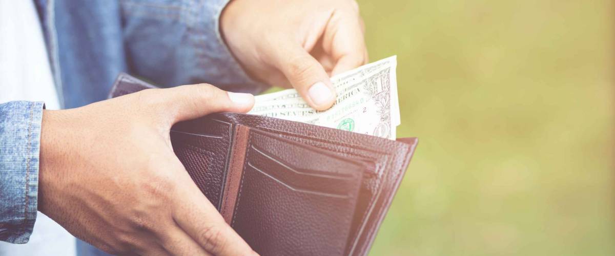 Businessman Person holding an wallet in the hands of an man take money out of pocket.