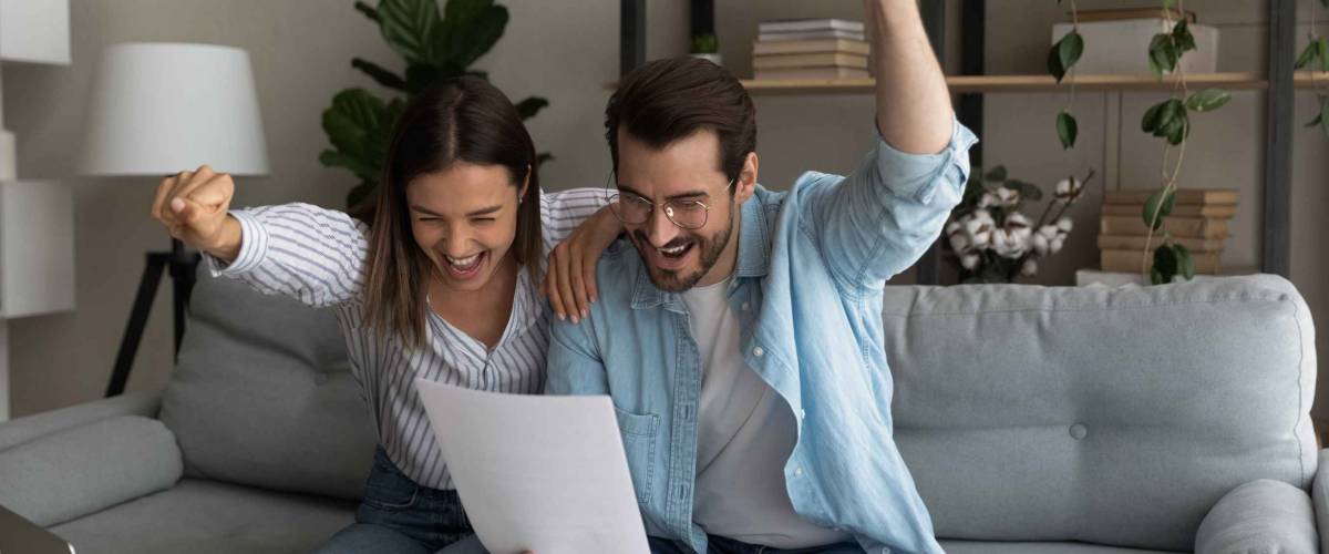 Happy young couple after being approved for mortgage