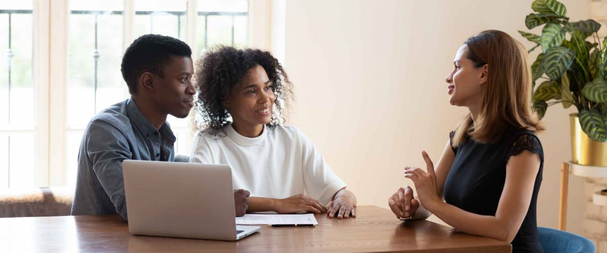 Young couple talks to a mortgage broker