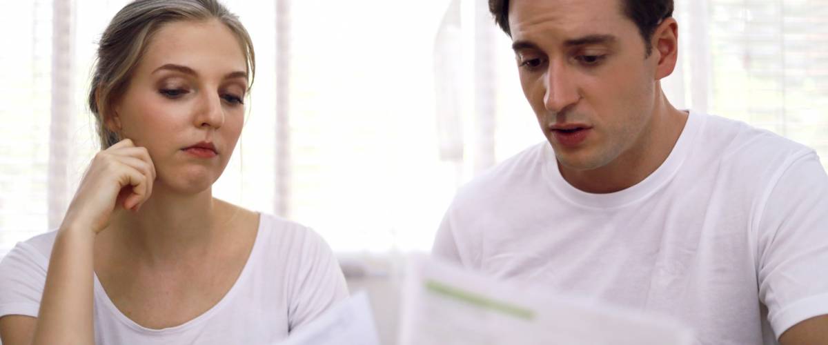 Young couple have bills for money.