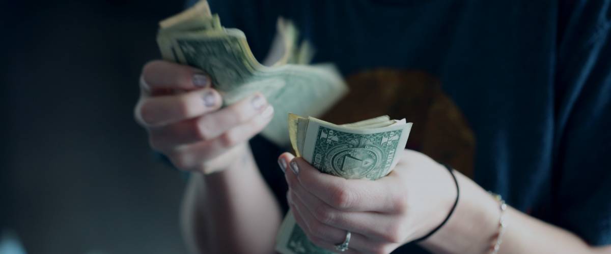 Hands counting bills, American cash