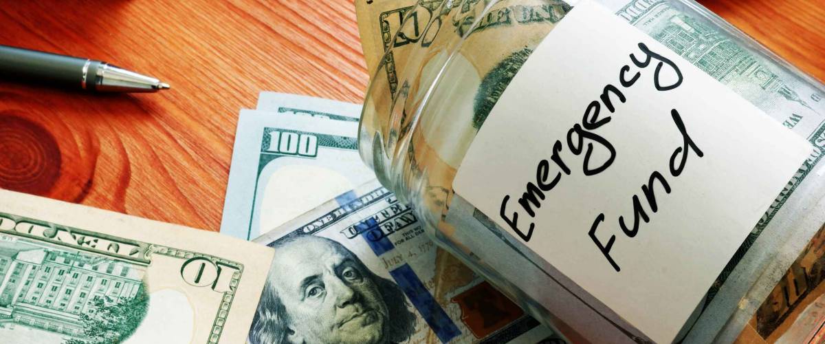 Emergency fund in the glass jar with cash.