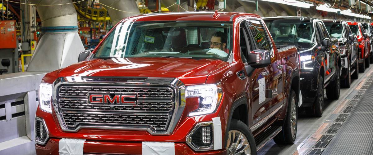 Trucks come off the assembly line at GM's Chevrolet Silverado and GMC Sierra pickup truck plant
