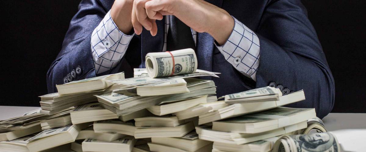 Man holding Money in hand at Black Background, Man receive a lot Money from Trading, Business Success Concept.