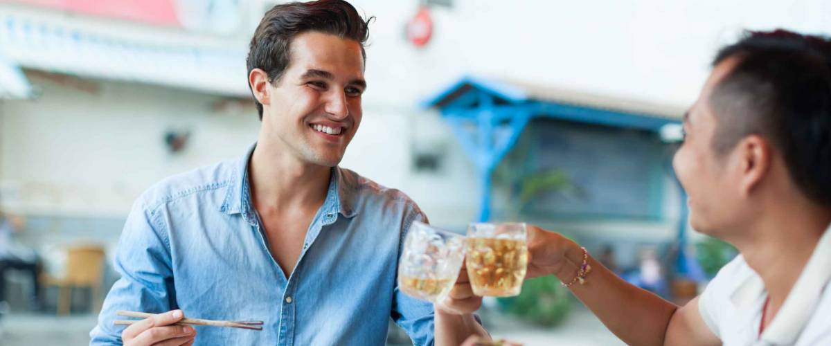 Tourist Men Cheers Toast Drink, Asian Mix Race Friends Guys Happy Smile Sitting at Cafe Eating Asian Food Street Local Cafe