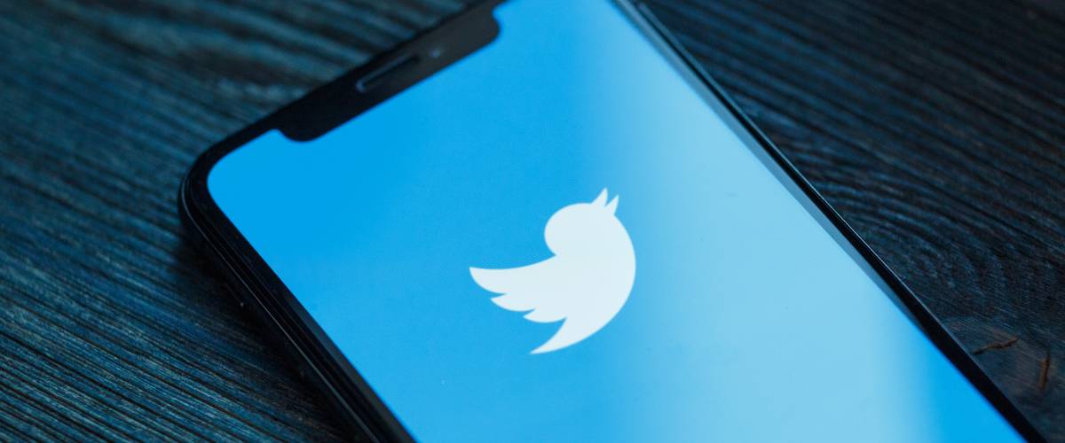 Twitter application icon on Apple iPhone X smartphone screen close-up.