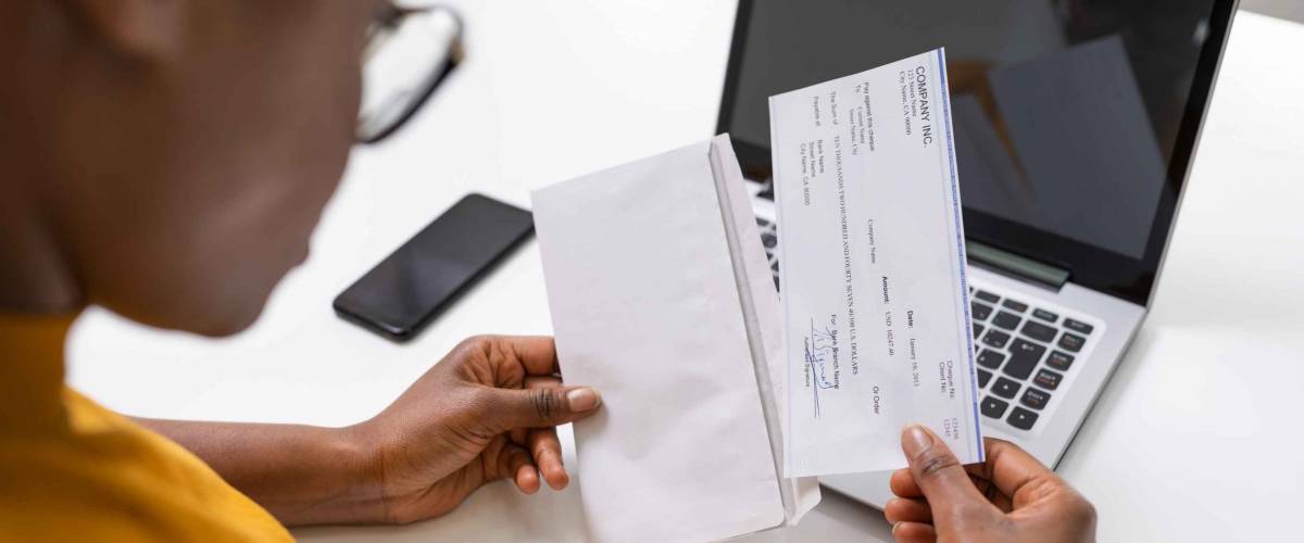 Woman Holding Paycheck Or Payroll Check