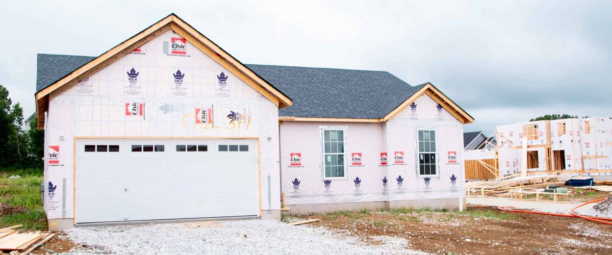 MOSCOW MILLS, MISSOURI - July 30, 2021: A nearly finished 2 story new construction home in a master plan community is ready for siding and trim during the building boom.