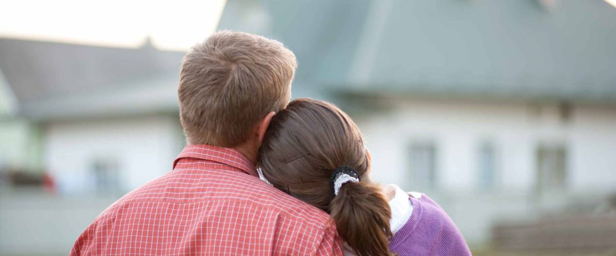couple looking on house