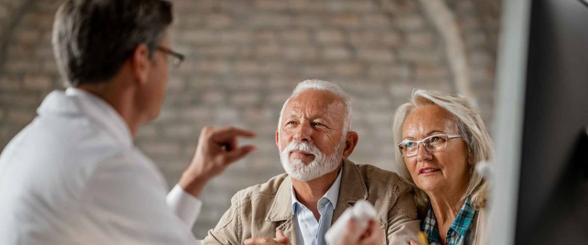 Senior couple having consultations about their supplement pills with a doctor.