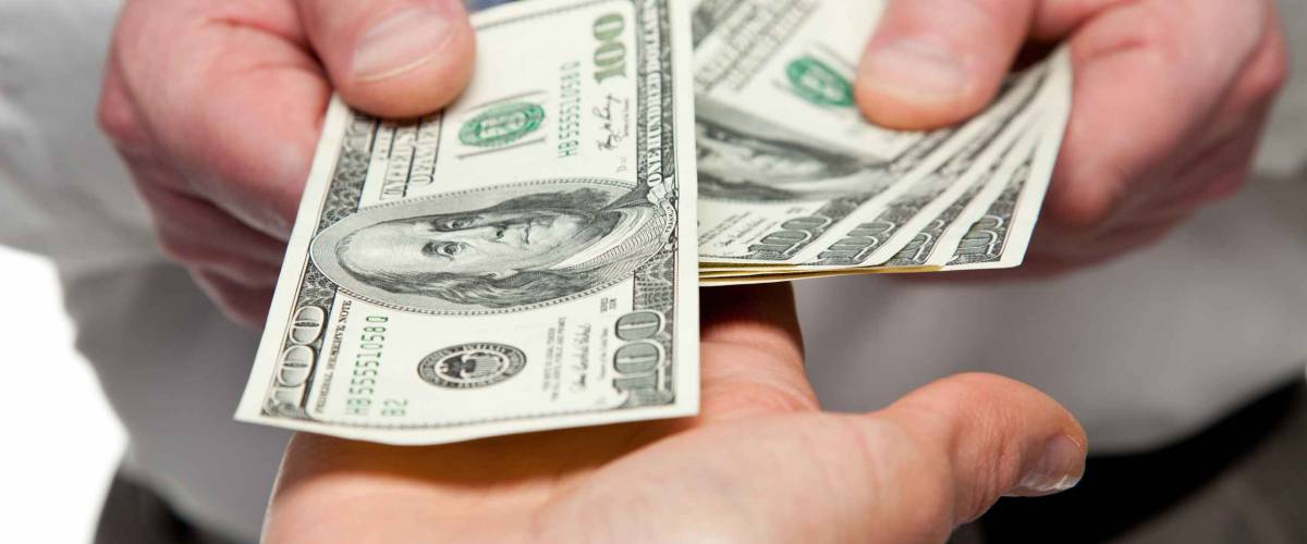 Human hands exchanging money - closeup shot