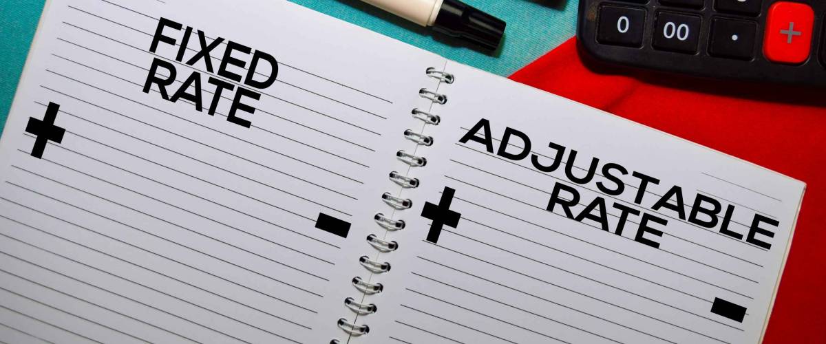 Fixed Rate and Adjustable Rate text on a book isolated on office desk.
