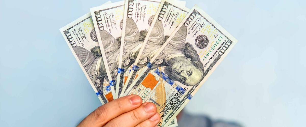 dollars in the hands. Businessman in blue shirt holding a 500 dollars. a fan of money