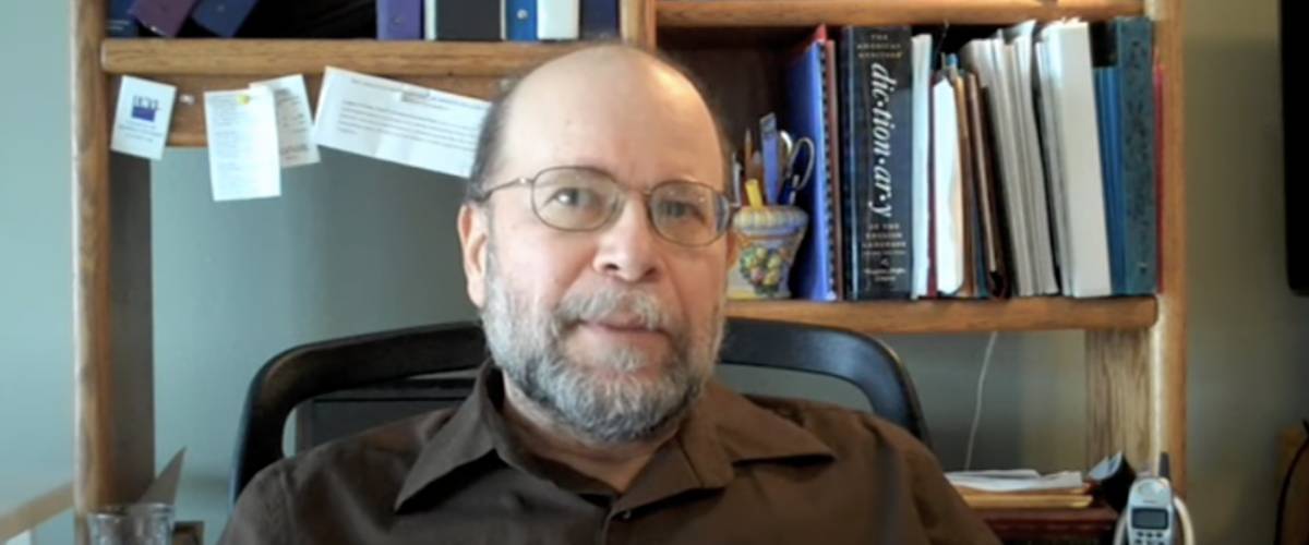 William Bernstein looks at camera, sitting in front of a bookshelf.