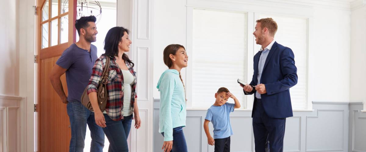 Realtor Showing Hispanic Family Around New Home
