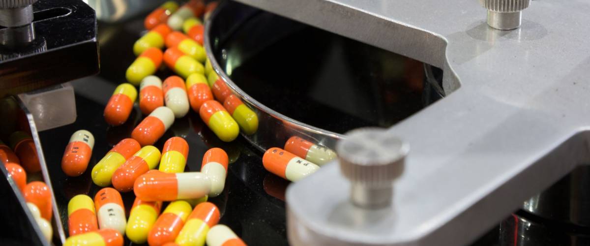 pharmacy medicine capsule pill in production line at medical factory. selective focus.
