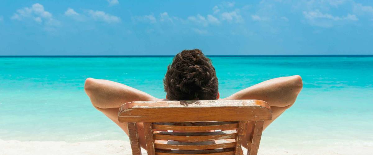 Man relaxing on beach, ocean view, Maldives island