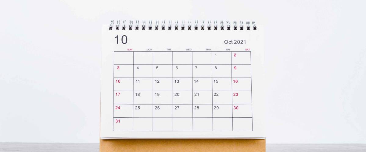 October Calendar 2021 on wooden table background.