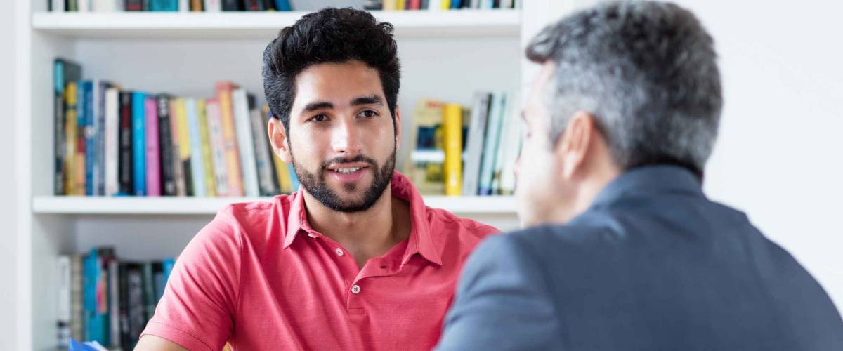 Job interview of north african male apprentice with businessman at office