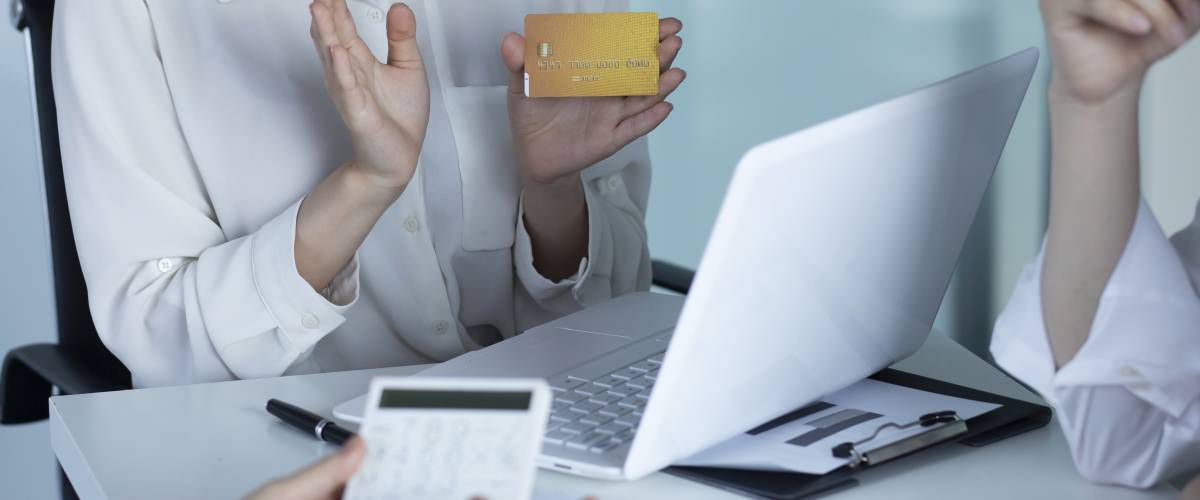 Image of business people meeting with a credit card.