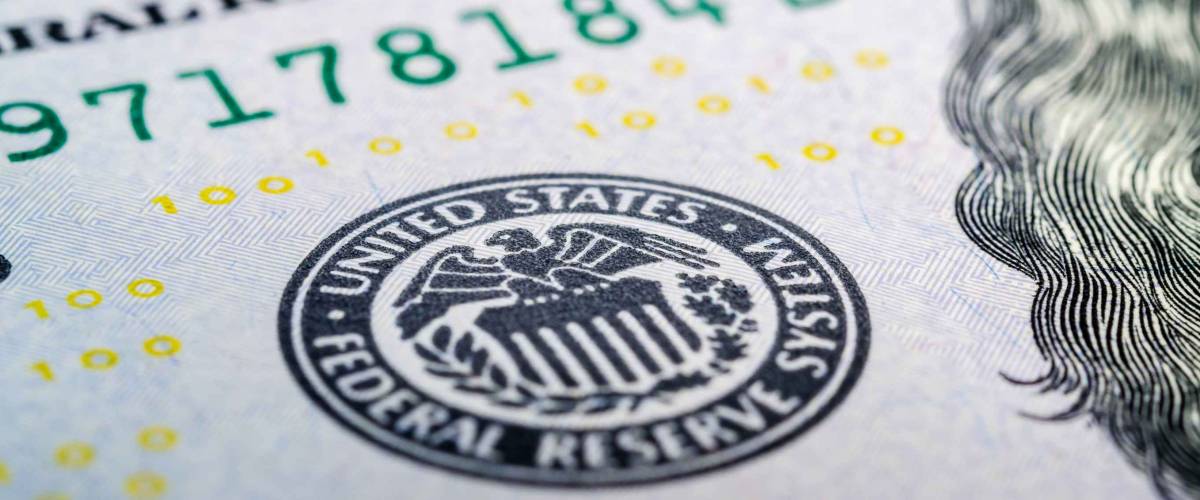 Federal reserve system symbol on hundred dollar bill closeup macro shot