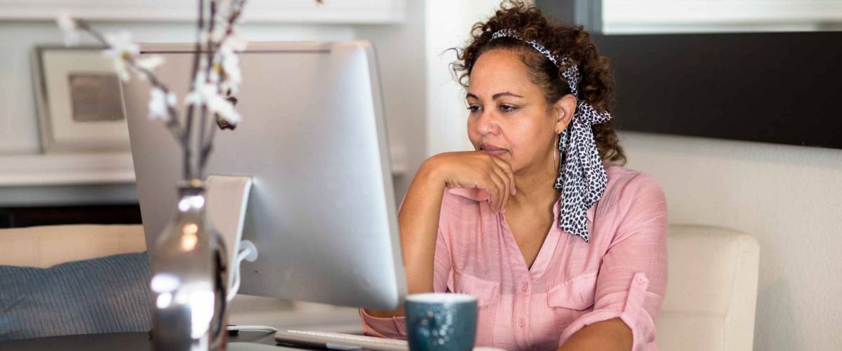 Woman concentrating and working from her home office.