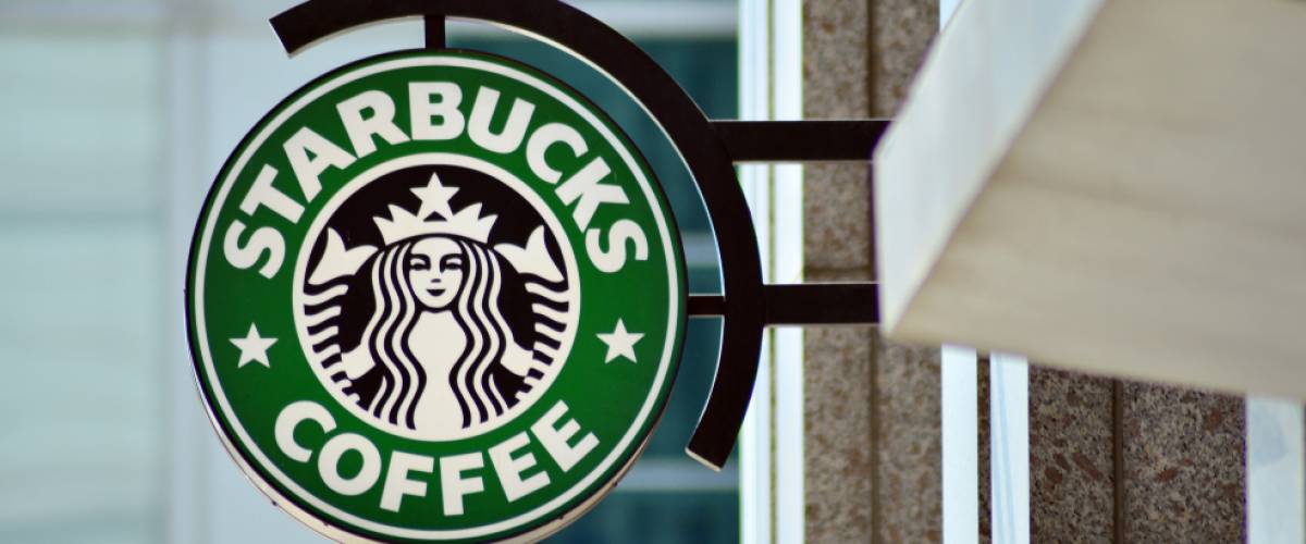 Sign Starbucks Coffee. Company signboard Starbucks Coffee.