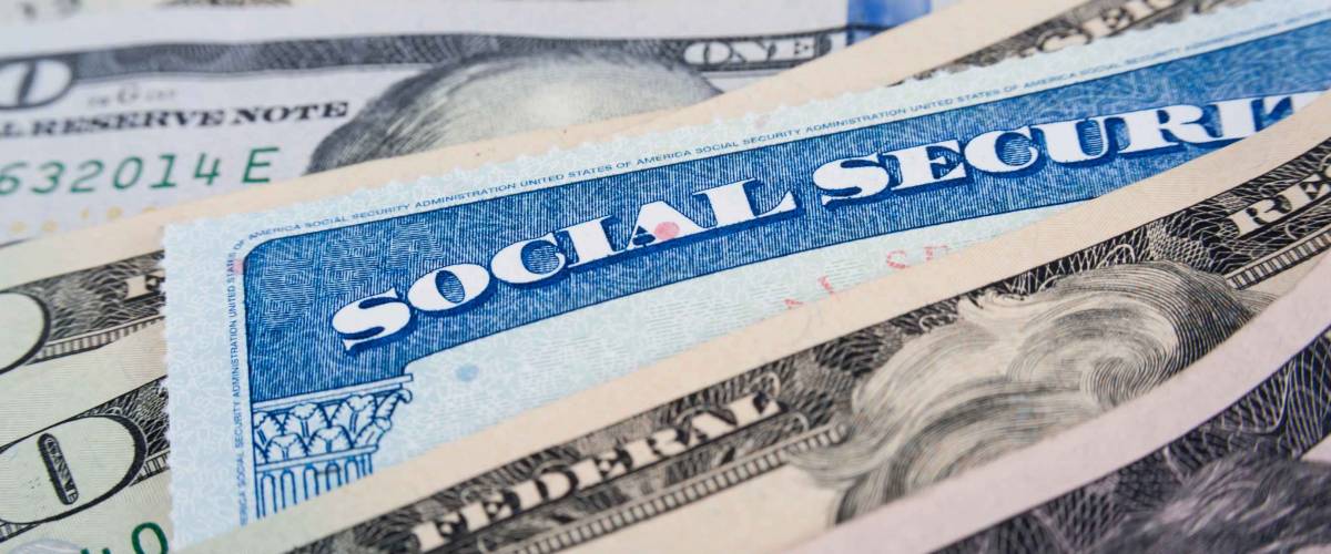 Social security card and American money dollar bills close up concept
