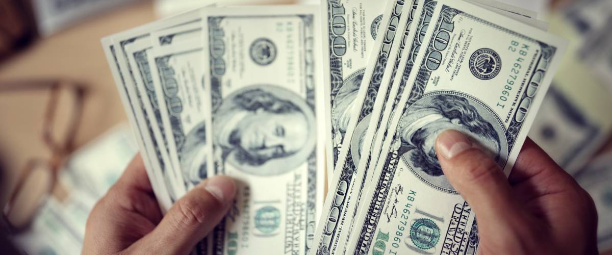 Holding money.