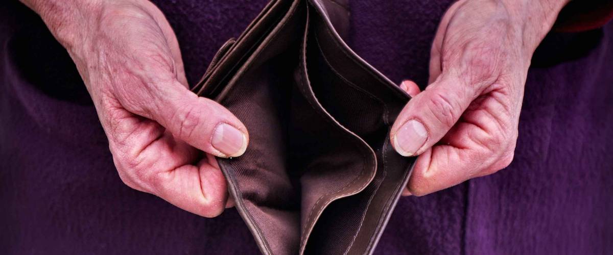 Old woman Hands holding open an empty wallet. Finance problems.