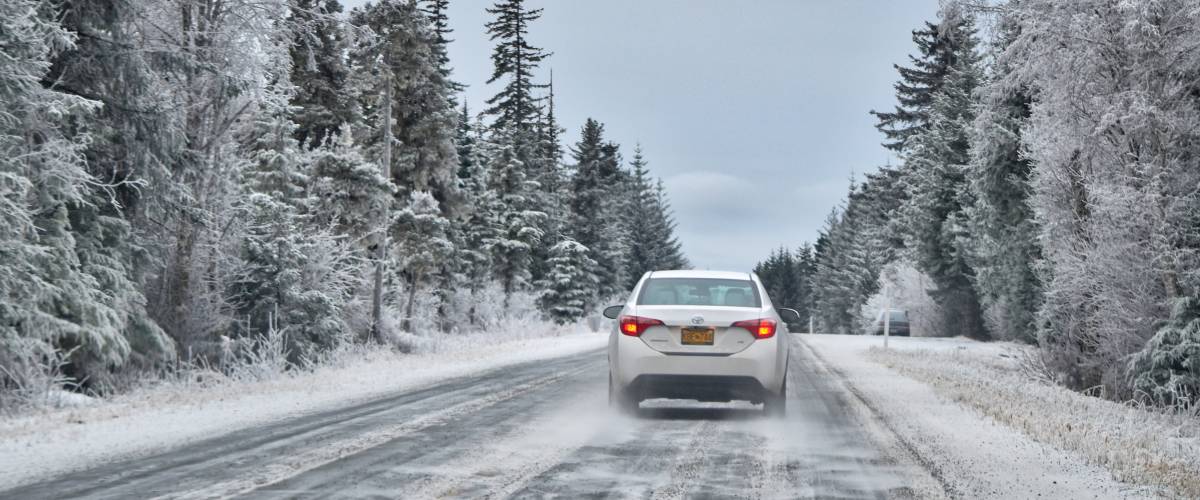 Snowy winter road dangerous driving conditions.