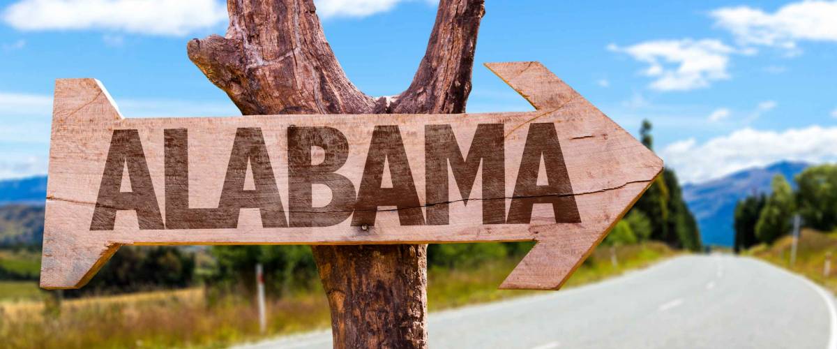 Alabama wooden sign with road background