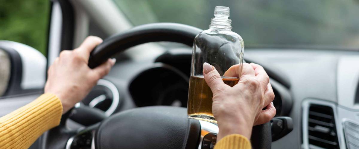 Woman drinking alcohol while driving