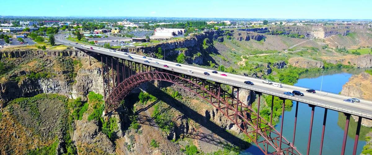 Perrine Bridge, Twin Falls, Idaho, USA - Distant Aerial View Over River Canyon With Cars Driving On Road