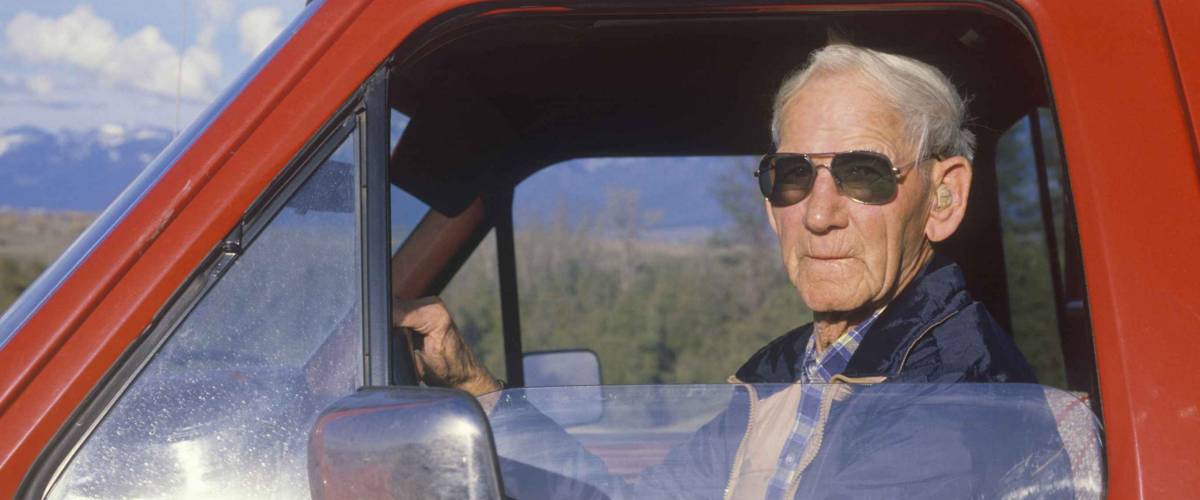 A senior citizen in a red pickup truck, National Bison Range, MT