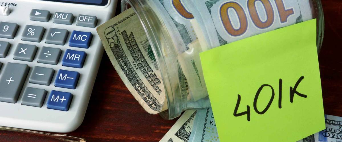 Jar with label 401k and money on the table.