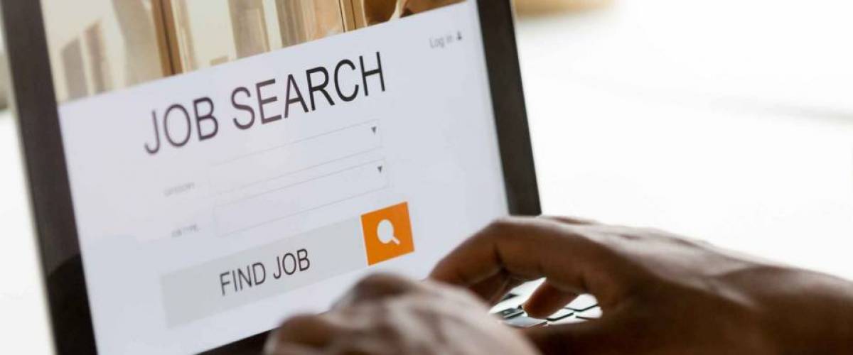 Black man browsing work opportunities online using job search computer app