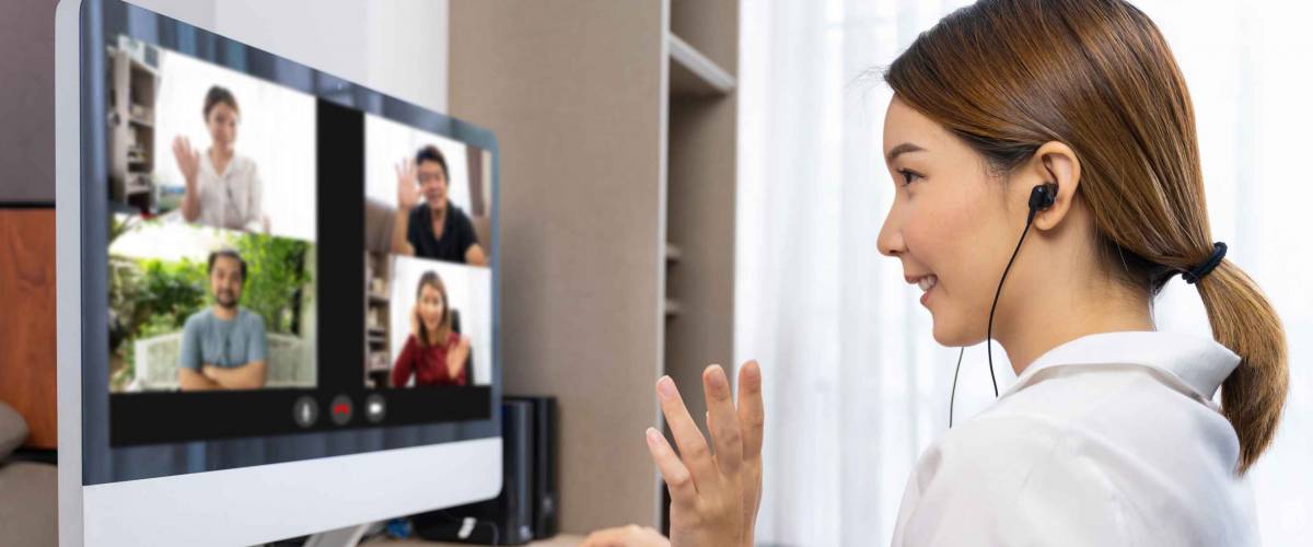 Young asian chinese ethnicity using laptop for meeting online, social distancing, quarantine, online conference