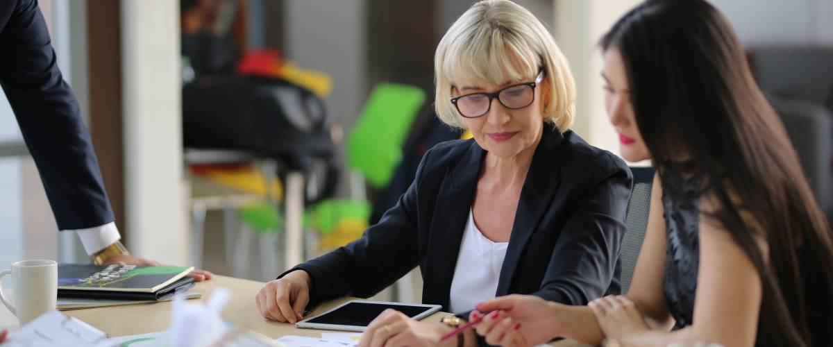 Professional meeting, two women discuss files