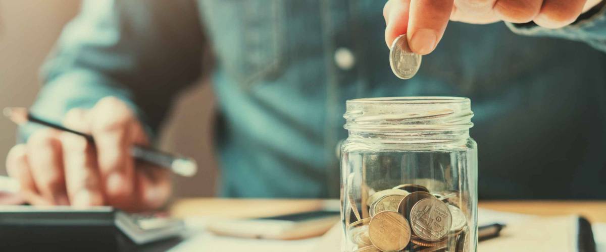 businessman holding coins putting in glass. concept saving money for finance accounting