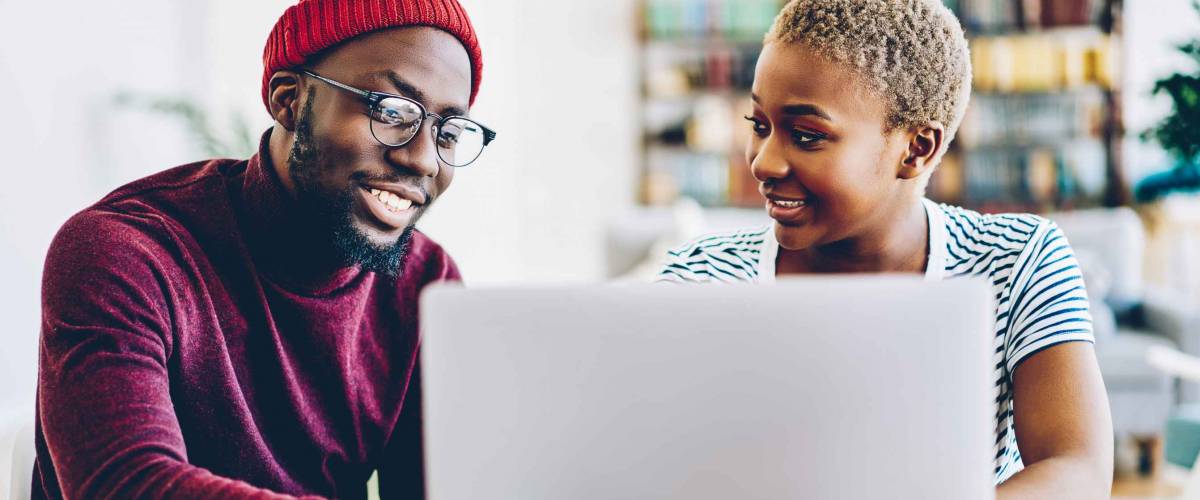 African american couple browse website on laptop computer, looking for low mortgage rates.